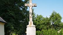 Mezi skromné jubilanty patří i kamenný kříž umístěný hned vedle kapličky  v centrální části Nového Dvora.