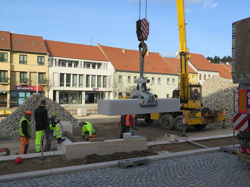 Na náměstí se právě umísťují betonové bloky budoucího schodiště.