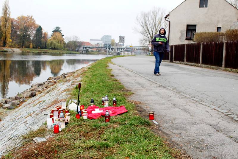 Zhruba tři desítky planoucích svíček, tričko a další vzpomínkové předměty. Tak vypadá pietní místo na labském břehu před Starou rybárnou.