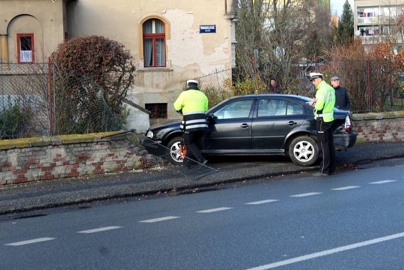 Po smyku skončil řidič v plotu rodinného domu.