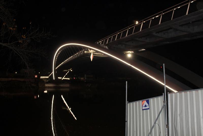 Nasvícená právě dostavěná lávka pro chodce a cyklisty přes Labe se stává novou dominantou města.