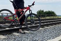 Cyklisté u Olomouce přecházejí hlavní železniční koridor, červen 2021