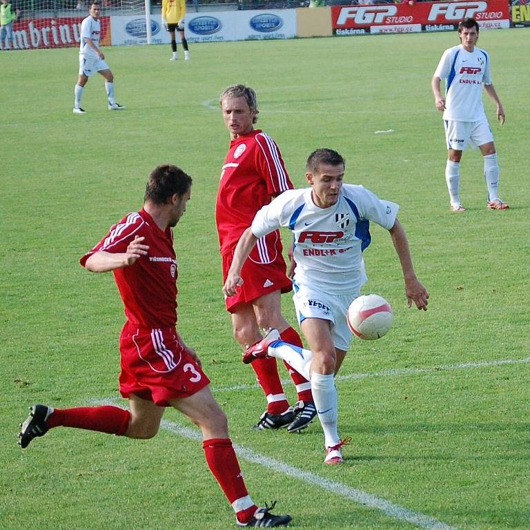 Útočník HFK David Korčián (s míčem) prošel do šestnáctky přes stopera Třince Reného Formánka.