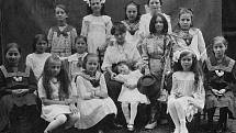 Historický snímek z roku 1912 zachycující účastnice školního divadelního představení „Dráteník“ v obci Komárov. Zcela vpravo sedící je Hedvika Vondřichová, budoucí manželka dalšího Poldaufova syna, Antonína ml.
