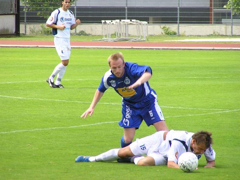 Kladenský Ondřej Szabó se snaží získat míč v souboji s ležícím záložníkem Viktorie Plzeň Petrem Šímou v přípravném fotbalovém utkání v Praze. 