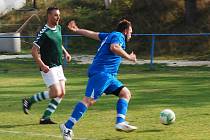 Vyhrocený duel ve Vstiši skončil výhrou Radkovic. Na snímku odkopává míč radkovický Jaroslav Stehlík (v modrém) před domácím Pavlem Purdešem.