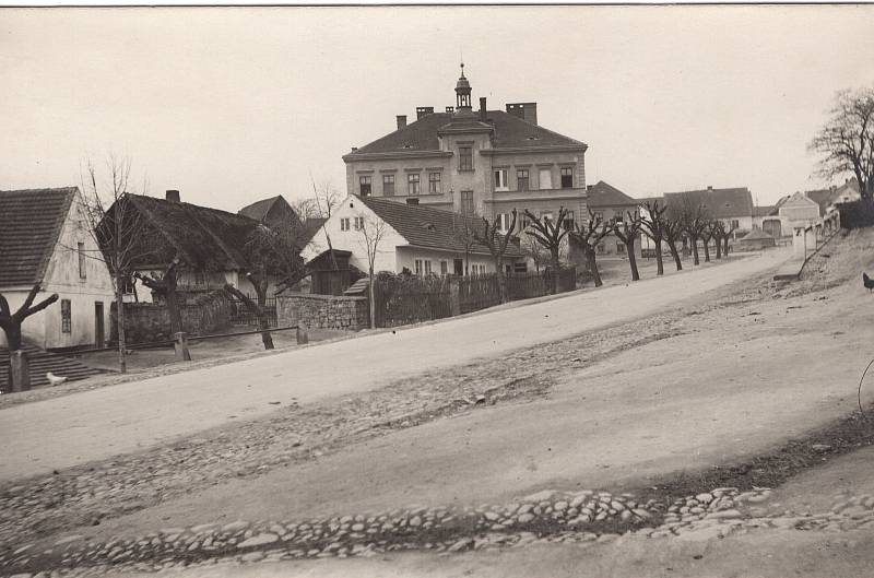 Na snímku je zachycena Bolevecká náves směrem ke staré škole ve 30. letech 20. století.
