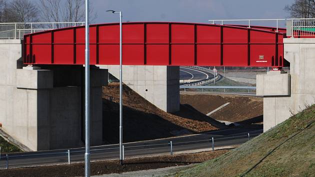 Stavba okružní křižovatky na Jižní tangentě ve Včelné v únoru 2023. Po dvojici zelených lávek povede chodník a cyklostezka, červené mosty jsou železniční.