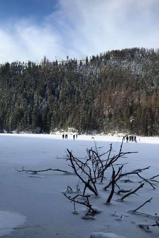 Neukáznění turisté na zamrzlé hladině Čertova jezera, které leží v Národní přírodní rezervaci. Chodit se přitom smí jen po břehu, po značených cestách.