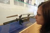 Velkou výstavou si Regionální muzeum Český Krumlov připomíná tři výročí: 125 let muzejních snah ve městě, 100 let od otevření německého muzea a 70 let od založení toho současného.  Jedním z lákadel je japonský meč, před ním kurátorka Vladimíra Podaná.