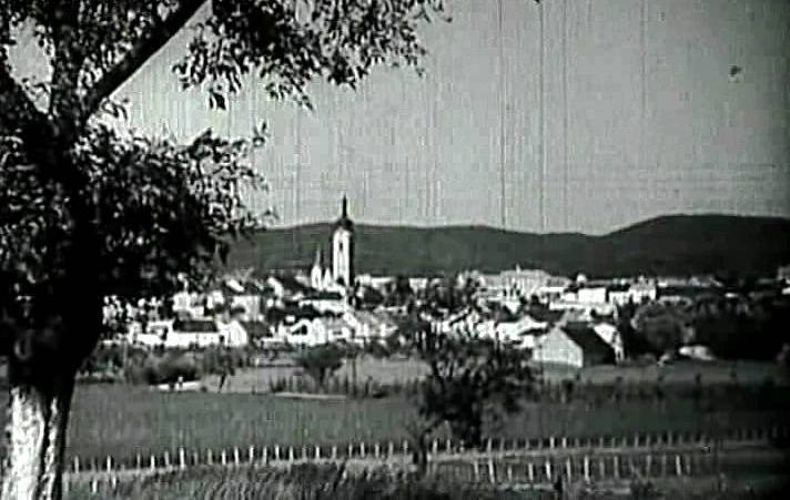 Kameraman Václav Vích nejprve zabere panorama s věží děkanského kostela Narození Panny Marie v Písku (v pozadí vystupují Písecké hory).
