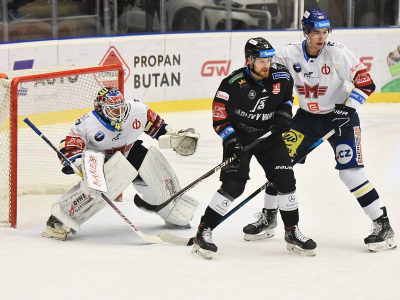 Gólman Motoru Dominik Hrachovina vykukuje přes clonícího Dávida Grígera, kterého blokuje Mikuláš Hovorka. Jihočeši prohráli s Karlovými Vary 0:3, v pátek je čeká duel na Kladně.