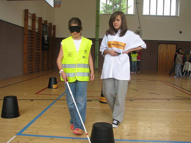  Desetiletá Zuzka Skalová si zkouší chůzi se slepeckou holí na soutěži Neviditelný svět pohybu, která se konala v pondělí  na Základní škole v Pohůrecké ulici.