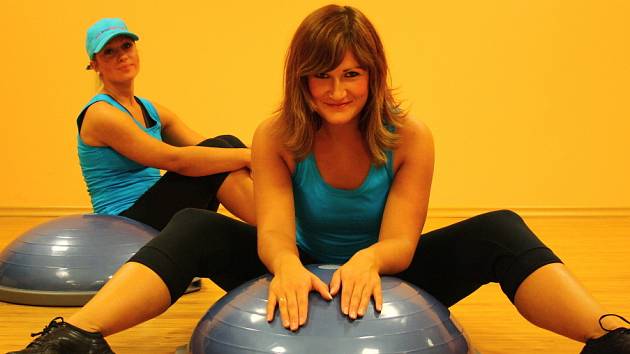 Při cvičení na BOSU komplexně posilujete všechny tělesné partie a navíc zredukujete přebytečný tuk. Něco o tom ví i fitness poradkyně Monika Švárová (v popředí) a Andrea Kopačková.