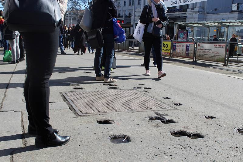 Pádem nebo vyvrknutým kotníkem může skončit chůze po tramvajových nástupištích před brněnským hlavním nádražím. Po odstranění starých laviček a jejich výměně za nové tam totiž zůstaly v asfaltu díry. 