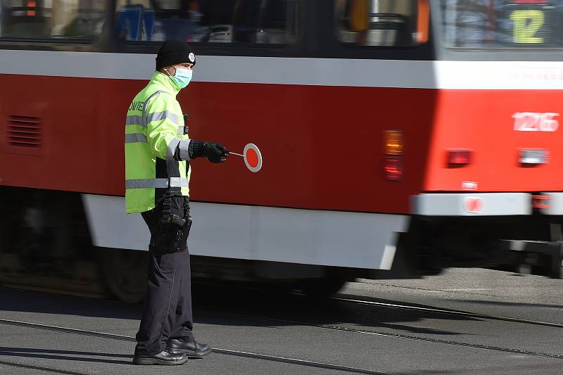 Brno 2.4.2020 - policista v roušce řídí dopravu v křižovatce ulic Veveří a Kotlářská