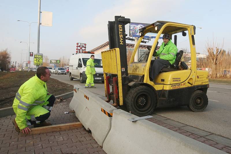 Odstraňování betonových bloků v brněnské ulici Sportovní.