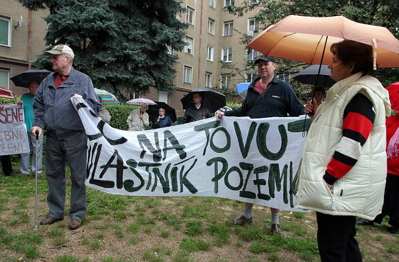 I v deštivém počasí lidé demonstrovali proti stavbě rezidence Erasmus.