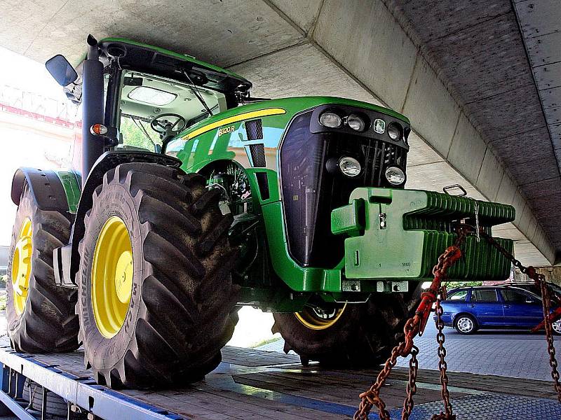 Řidič nákladního auta, které převáželo nový traktor, neodhadl výšku svého nákladu a v podjezdu se zaklínil.