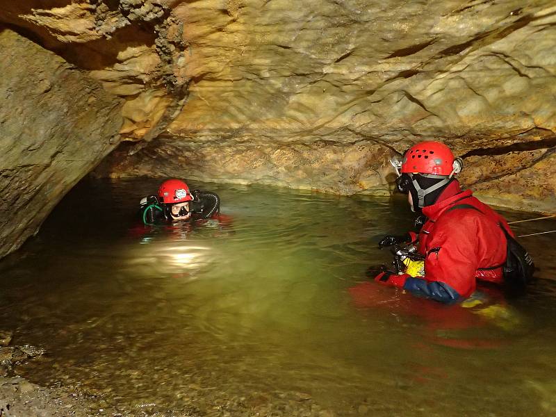 Potápěči při přípravě k ponoru v zatopené části jeskyně.