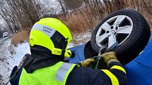 Zásah hasičů u nehody osobního automobilu Škoda Octavia, která skončila v hlubokém příkopu na střeše.