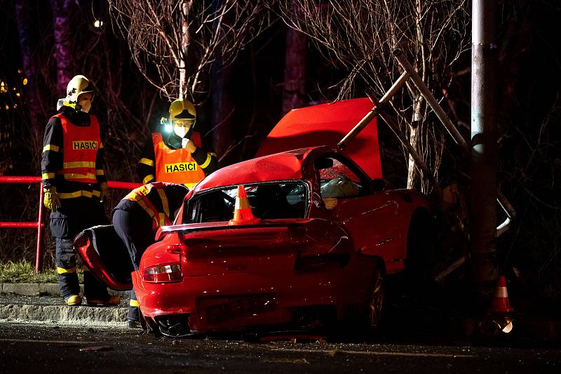 Nehoda vozidla zn. Porsche ve večerních hodinách na ulici Plzeňská, vedle tramvajové zastávky Dolní směr Ferona. 12. března 2021 v Ostravě.