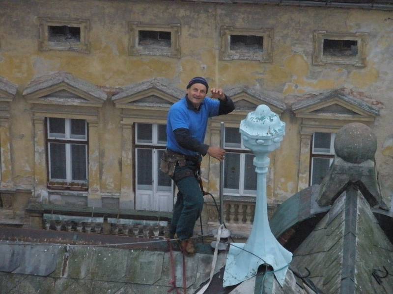 Postřelmovský horolezec při opravě střechy radnice v Šumperku.