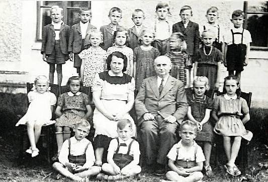 TŘÍDA 1. b ve školní roce 1950/1951. Do první třídy nastoupilo přes 40 dětí. Na fotografii jsou kostelečtí spolužáci s třídní učitelkou Marií Neokařovou a ředitelem školy Osladilem.