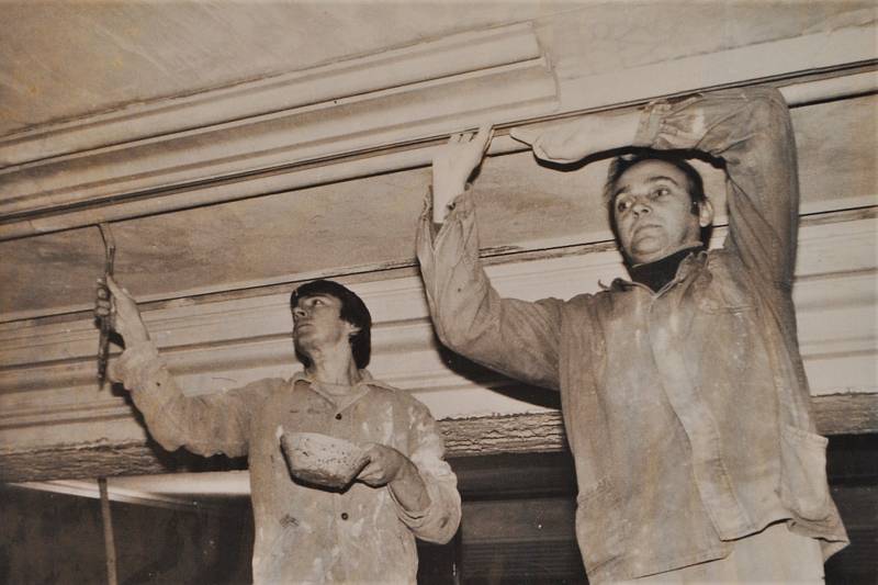 Český Krumlov v roce 1992. Pan Pazderka s řemeslníky své dílny při štukatérských pracích v divadle.