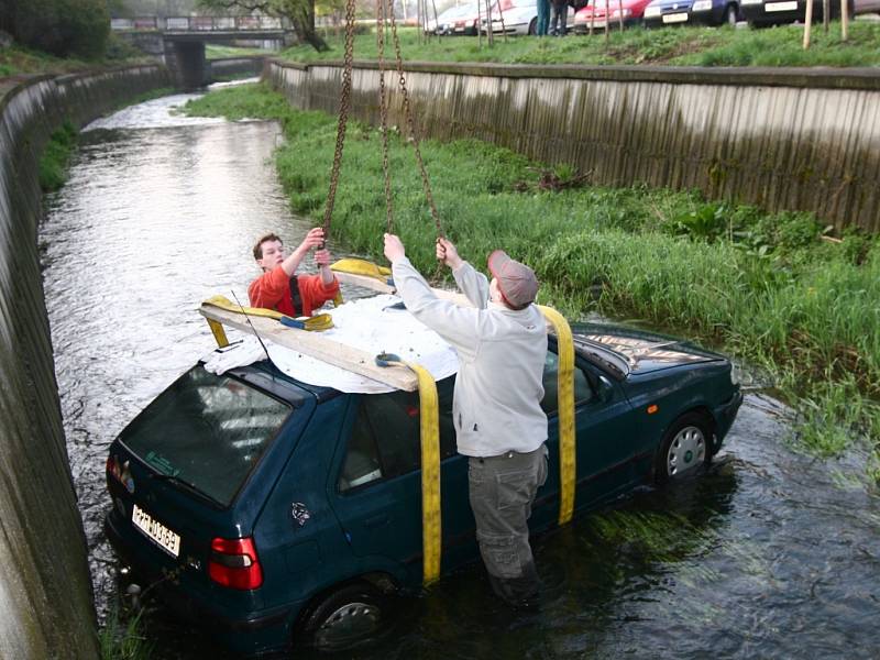 Nejprve bylo třeba vlézt do potoka a auto připevnit, aby je mohl jeřáb vytáhnout. 