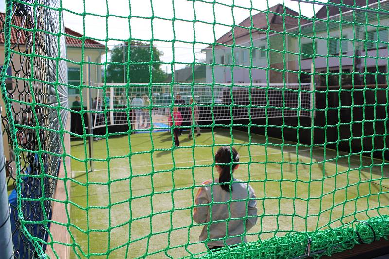 Sportovní delegace olympijských medailistů v doprovodu starosty Lumíra Kreisla a ředitele školy Břetislava Leblocha vešli do školní brány v Horním Němčí, aby společným přestřižením pásky otevřeli nový areál hřiště a dvora.