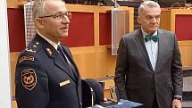 Ředitel pražských hasičů převzal z rukou primátora pamětní list a medaili.