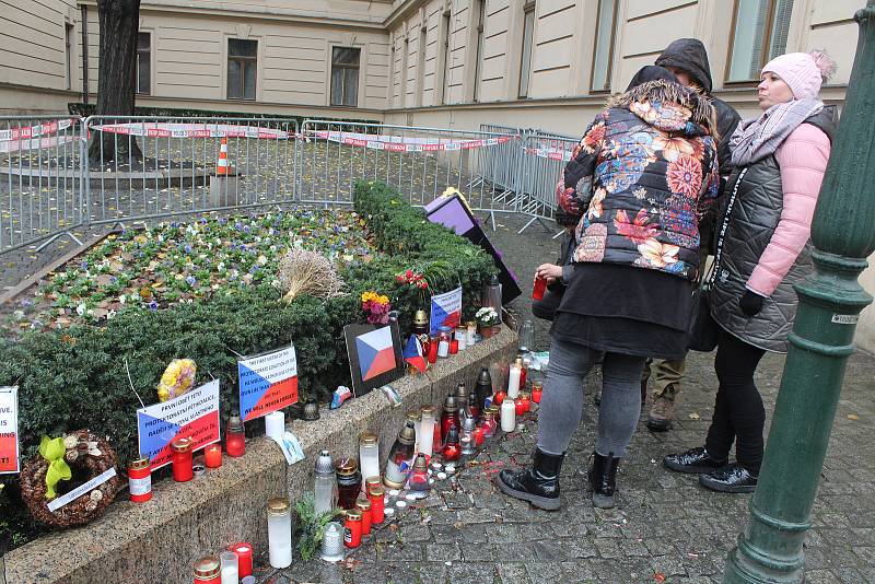 Občané u Úřadu vlády zapalují svíčky na pietním místě kde se zastřelil sebevrah.