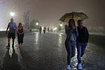 Charles Bridge - Some tourists and photographers enjoy the night rain, 19/08/2022.