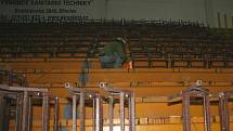 Dělníci demontují staré sedačky na tribunách břeclavského zimního stadionu.