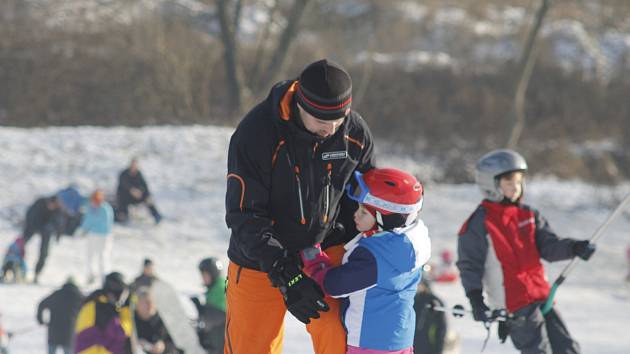 Na pomu, která vyváží malé i velké lyžaře nad kopec, stojí v pátek dopoledne fronty. Instruktoři i rodiče se zejména věnují dětem od tří let nahoru. Rozběhla se i školička pro děti, které se nedostaly do dlouhodobého kurzu.
