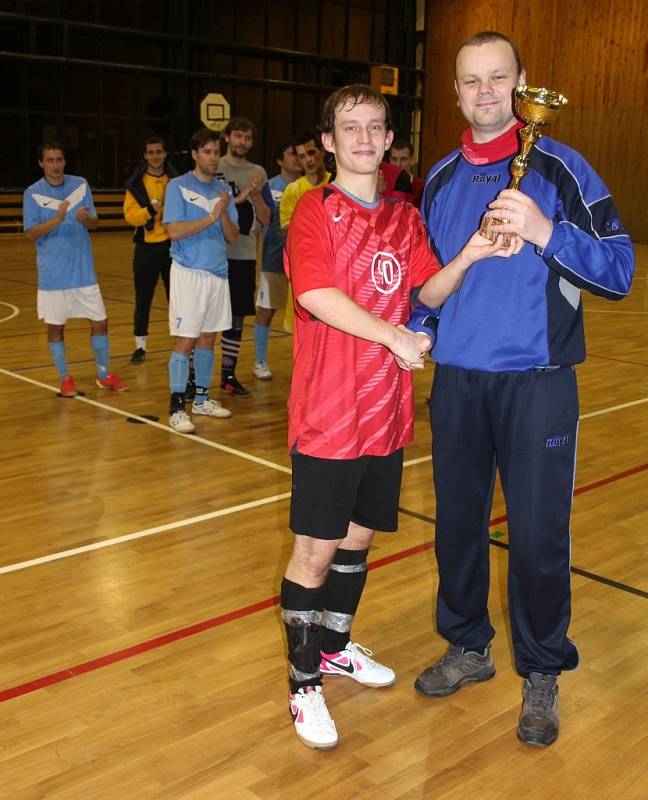 Organizátor futsalové ligy Pavel Urbánek předává pohár kapitánovi nejúspěšnějšího mužstva Romanu Švarcovi, který je zároveň také pořadatelem turnaje.