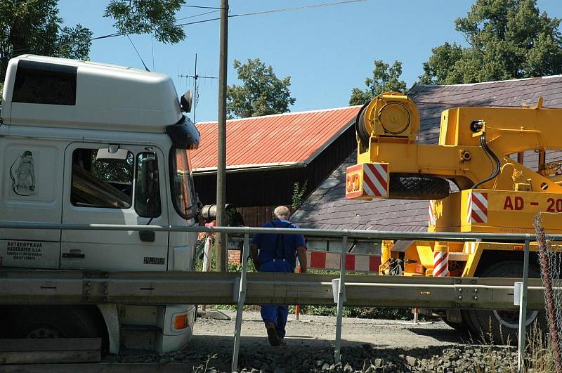 Kamion naložený hutním materiálem se pokoušel projet po provizorním mostě ve Volfarticích. Utrhla se s ním krajnice a museli jej vyprostit jeřábem. 