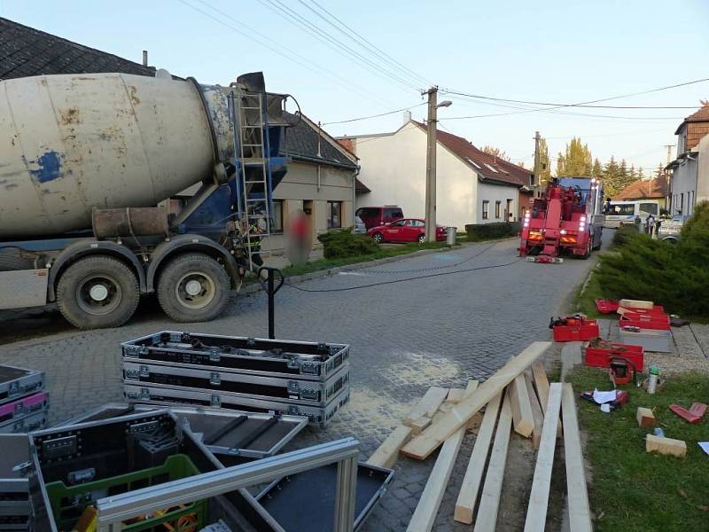 Míchačka slisovala auto v Brankovicích na Vyškovsku a ještě nabourala rodinný dům. Hasiči museli budovu zajistit.