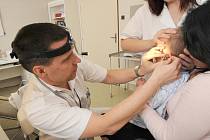 Přednosta otorinolaryngologické kliniky ostravské fakultní nemocnice Pavel Komínek na snimku vyšetřuje, zda miminko slyší.