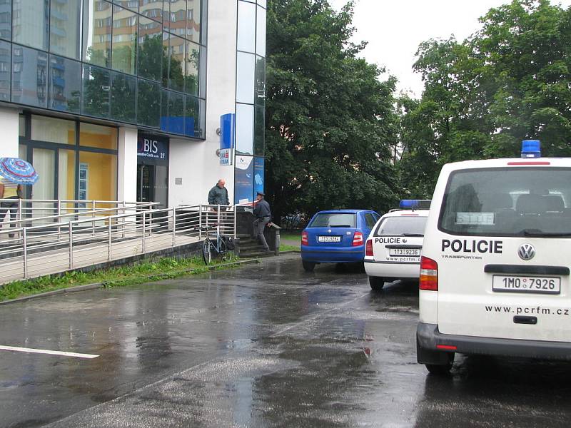 Policie před pobočkou České spořitelny na ulici 8. pěšího pluku ve Frýdku-Místku, kterou zatím neznámý pachatel přepadl ve čtvrtek 24. července o půl dvanácté.