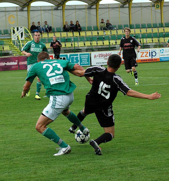 Martin Motyčka (v zeleném) zápolí se soupeře o míč.