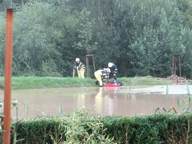 Dvě jednotky hasičů zasahovaly od úterního rána v okrajové části Hlučína v ulici U cihelny, kde voda a bahno zatopily přízemní části dvou obytných domů a jejich okolí.