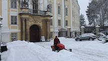 Sněhová nadílka první únorový den si vyžádala pořádný úklid. Sníh musel zmizet od bruntálského zámku i z parkoviště před obchodním domem.