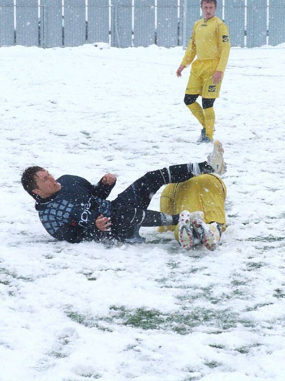 Hráči se v sobotu spíše trápili, než by si úživali fotbal. Na umělém trávníku totiž ležela sněhová pokrývka.