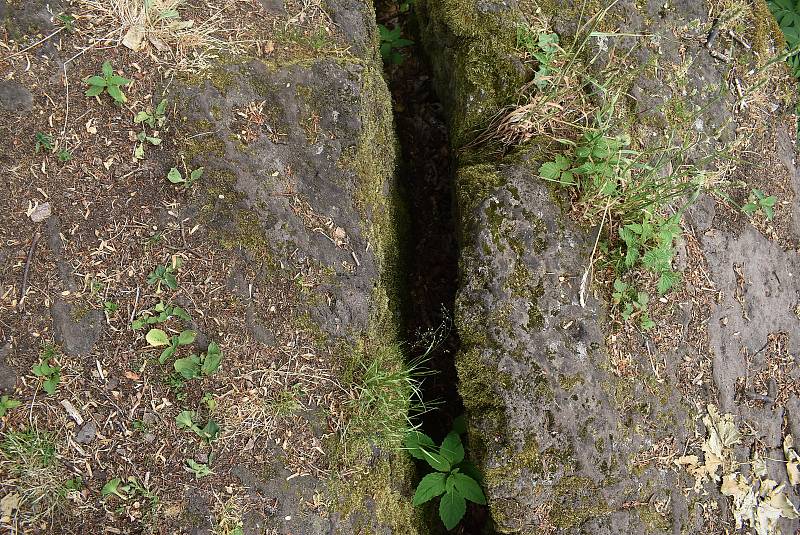 Na vrcholu sopky Velký Roudný je puklý stolový kámen s otiskem boží nohy. Přímo na vulkánu se prý totiž odehrál souboj Boha s Luciferem.